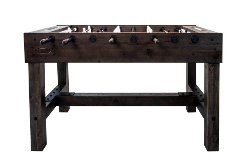 Front view of rustic wood foosball table with black handles and sturdy trestle-style base.