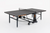 Foldable table tennis table with net, wheeled legs, and compact indoor design for home or recreational use.