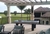 R&R Outdoor South Beach Pool Table set on a backyard patio with a golf course in the background.