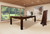 Modern pool dining table in a bright living room with large windows overlooking a garden.