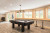 Canada Billiards Invitation Pool Table in a light filled room with widows.