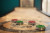 Red and green shuffleboard pucks on a wooden shuffleboard table. Red and green shuffleboard pucks on a wooden shuffleboard table.