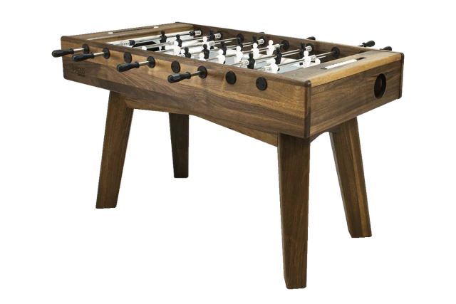 Walnut wood foosball table with black player figures and angled wooden legs, perspective view.