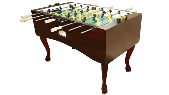 Traditional wooden foosball table with curved legs, green and yellow players on metal rods, isolated background.