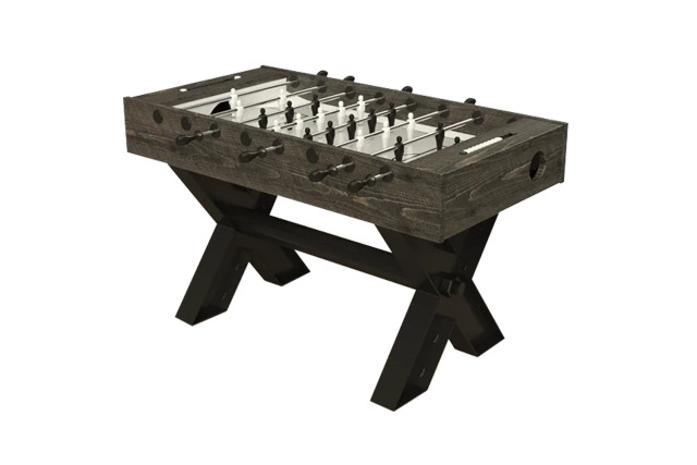 Rustic wooden foosball table with metal rods and players, supported by sturdy trestle-style angled base.