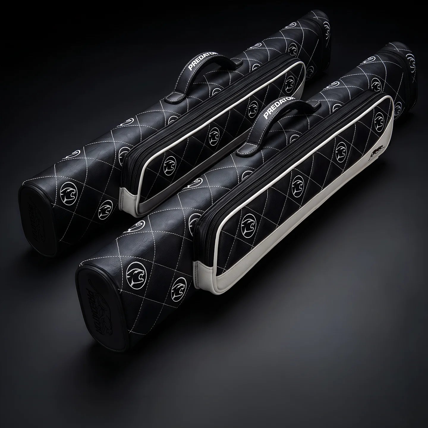 Predator cue cases on a dark surface.