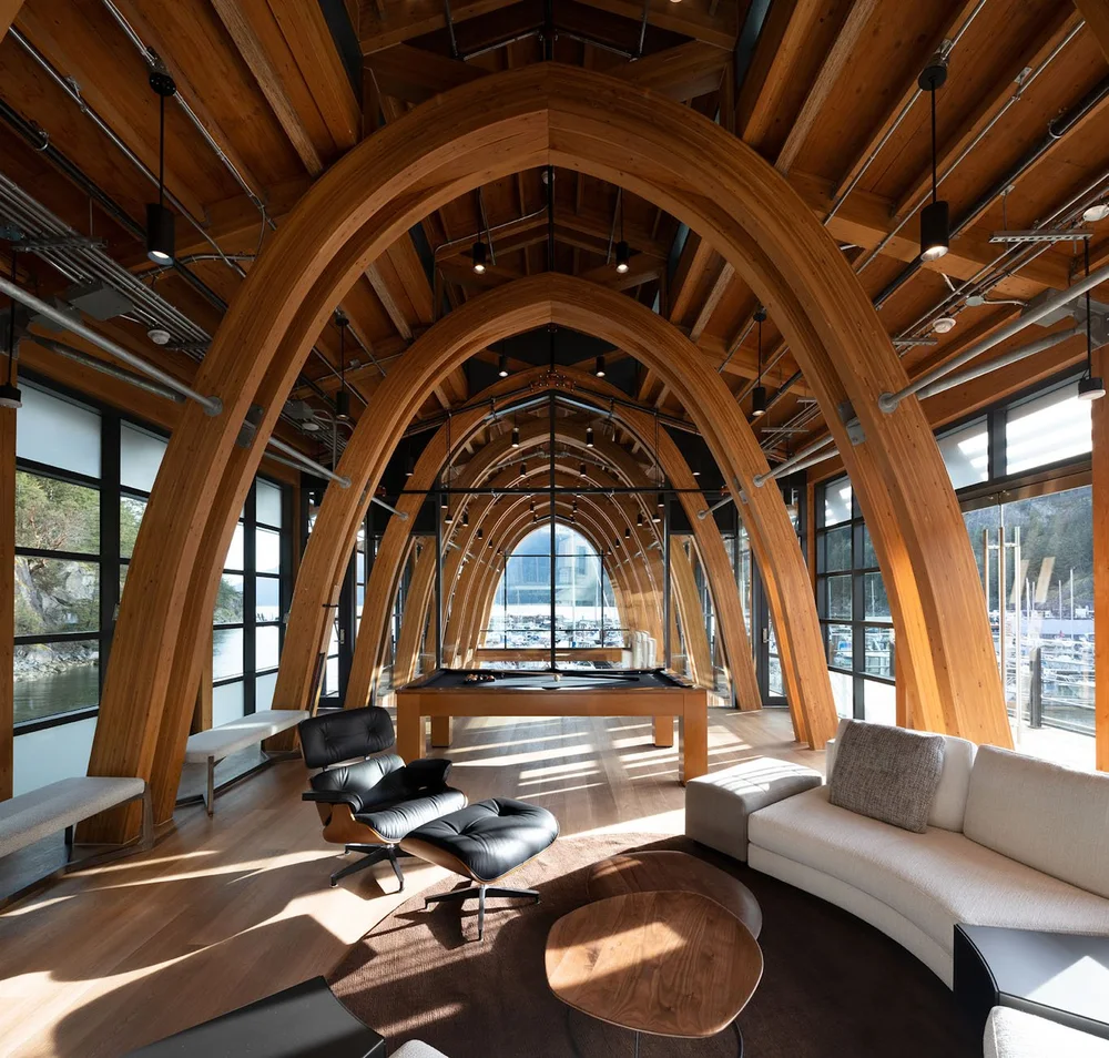 Pool table in a bright architectural living room.
