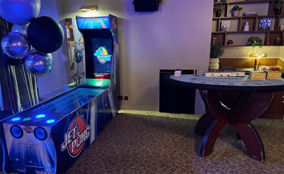 Jet-Pong game in an event lounge with balloons and another games table