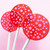 Three magenta pink lollipops on long white paper sticks are arranged against a light pink background in a fan layout. The lollipops each have a light pink pattern of dots.