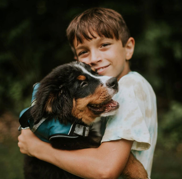 boy with Bernese puppy