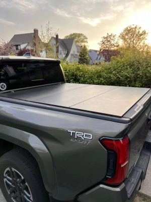 Shop Access LOMAX black urethane tri-fold tonneau cover for 2024–2026 Toyota Tacoma 6ft long bed. Low-profile hard folding cover. In stock.