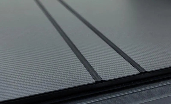 Shop Access LOMAX carbon fiber tri-fold tonneau cover for 2016–2023 Toyota Tacoma 6ft bed with deck rail system. Lightweight, low-profile hard cover. In stock.