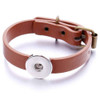 Brown leather adjustable snap bracelet with silver-tone snap button charm and antique brass buckle, stylish unisex accessory for customizable snap jewelry collections.