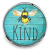 SnapAccents snap jewelry charm featuring a colorful bumblebee illustration on a turquoise wooden background with the word "KIND" in bold black letters, perfect for customizable bracelets and accessories.