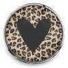 SnapAccents snap jewelry charm with black heart design on beige and brown leopard print background, round interchangeable snap button accessory for bracelets and necklaces, trendy animal print fashion jewelry piece.