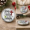 Round SnapAccents snap jewelry charm with "Jesus is the reason for the season" text, featuring a red and black buffalo plaid cross and green holly leaves, set against a festive red background with snowflake patterns.
