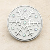 round snap jewelry charm with white enamel background featuring a silver snowflake design accented by iridescent AB crystals