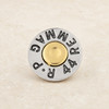 silver and gold-toned snap jewelry charm resembling a bullet casing with engraved text around the edge