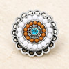 round snap jewelry charm with concentric circles of white and brown beads and a central aqua rhinestone set in a silver scalloped edge base