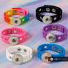Colorful SnapAccents snap jewelry silicone bracelets in rainbow, black, pink, purple, white, and blue with metal snap button bases, displayed on a pastel background.
