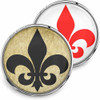 SnapAccents snap jewelry set featuring two interchangeable round snaps with fleur-de-lis designs; one with a vintage beige background and black fleur-de-lis, the other with a white background and red fleur-de-lis, perfect for customizable snap charm bracelets or accessories.