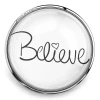 SnapAccents round snap jewelry charm with the word "Believe" in elegant black script and a heart detail, silver metal frame, inspirational accessory for interchangeable snap jewelry, perfect for bracelets, necklaces, and gifts.
