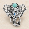 Elephant-shaped snap jewelry charm in silver tone with intricate cutout patterns, a turquoise stone on the forehead, and a blue accent on the trunk