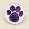 silver-tone snap jewelry charm with a purple glitter paw print design featuring one large pad and four smaller pads