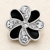 silver-tone snap jewelry charm shaped like a flower with alternating black enamel and clear rhinestone petals