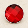 round snap jewelry charm with a faceted deep red surface and silver metal edge