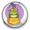 SnapAccents Halloween snap jewelry charm featuring a cute green frog wearing a purple witch hat sitting on a carved jack-o'-lantern pumpkin with a purple background, perfect for festive seasonal accessories.