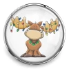 Round SnapAccents snap jewelry charm featuring a cute cartoon moose with colorful Christmas lights on antlers and a holly wreath collar, perfect for holiday-themed interchangeable snap jewelry, bracelets, and accessories, displayed on a wooden surface with festive bokeh background.