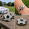 snap jewelry charm shaped like a black and white soccer ball with clear rhinestones on the white panels, shown loose and attached to a silver bracelet