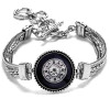 Silver-tone SnapAccents bracelet with intricate chain design and black circular snap charm featuring ornate silver detailing and central clear rhinestone, adjustable toggle clasp closure, stylish snap jewelry accessory for women.