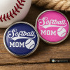 Softball Mom snap jewelry charms in navy blue and pink with white lettering and softball graphic, interchangeable snap accessories for sports moms, SnapAccents customizable jewelry pieces on wooden background with baseball and rope accents.