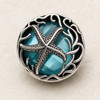 18mm silver snap jewelry charm with a detailed starfish over a faceted aqua blue gem and wavy silver patterns around the edge