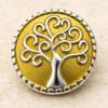 round snap jewelry charm with a silver tree of life featuring spiral branches on a textured gold-toned enamel background with a silver border