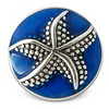 round snap jewelry charm with a silver-tone textured starfish on a deep blue enamel background