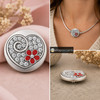 18MM snap jewelry charm with a rhinestone-filled heart, silver swirl, and a red flower with a central rhinestone, shown loose and on a silver necklace