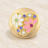 Gold heart-shaped snap jewelry charm with white and pink enamel daisies and multicolored rhinestones on a gold base