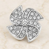 silver-tone snap jewelry charm shaped like a windmill with clear rhinestones arranged in swirling blades and a central rhinestone