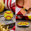 snap jewelry charm with yellow rhinestones and red rhinestone stitching resembling a softball, shown loose and installed on a black leather bracelet