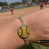 snap jewelry bracelet with a round charm featuring yellow rhinestones and red rhinestone stitching resembling a softball