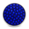 round snap jewelry charm covered with multiple royal blue rhinestones set in a silver-tone base