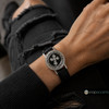 snap jewelry bracelet with a black leather band featuring a round silver-tone snap charm with a rhinestone-studded Celtic cross on a black background and decorative border