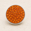 round snap jewelry charm covered with multiple bright orange rhinestones set in a silver-tone metal base