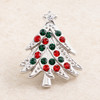 Small silver snap jewelry charm shaped like a Christmas tree with red and green rhinestones and a clear rhinestone star at the top