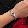 silver-tone snap jewelry bracelet with a round snap featuring a large red faceted rhinestone center surrounded by clear rhinestones