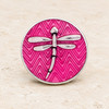 round snap jewelry charm with a silver dragonfly on a pink chevron enamel background