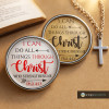 SnapAccents snap jewelry featuring inspirational Bible verse "I can do all things through Christ who strengthens me" Phil. 4:13, two interchangeable snap charms with white and gold backgrounds, displayed with a silver cross necklace on a tan surface.